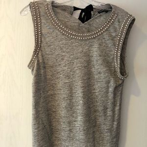 Sleeveless top with crystals and beads.